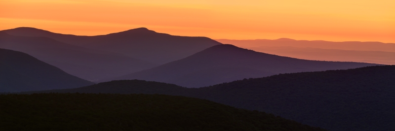 Golden hour lights up the profile of the Northern Catskill Mountains